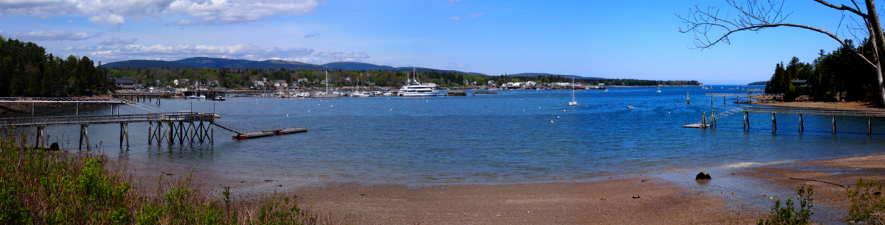 [Four photos stitched together showing the bay with multiple docks and ships visible.]